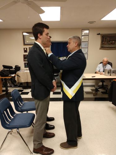 Anthony_Brooks_pins_First_Degree_pin_onto_his_two_sons